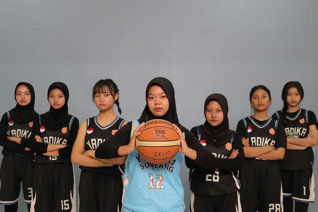 A group of young women in basketball uniforms
