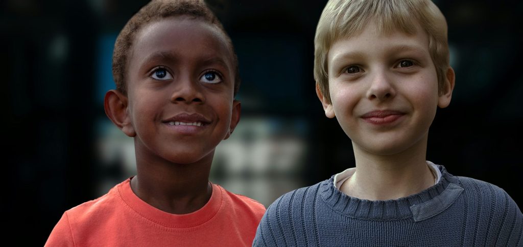 boy in red crew neck shirt smiling